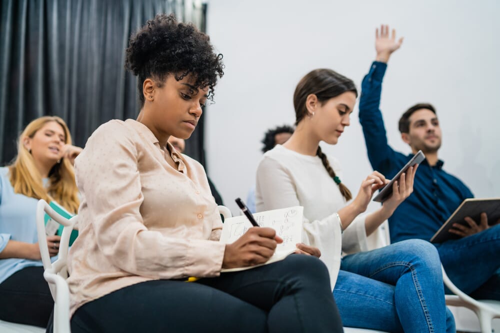 lady holding up a notebook written startup